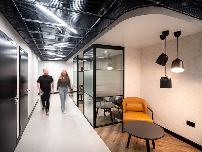 The image shows an example of neuroinclusive workplace design with quiet spaces for employees to focus